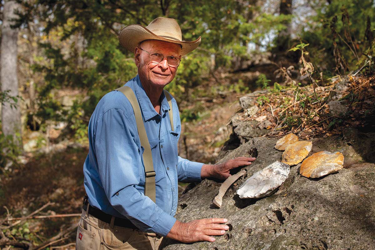 Michael Collins stands with several chert cores—often called flint—recovered from the Gault site along Buttermilk Creek.